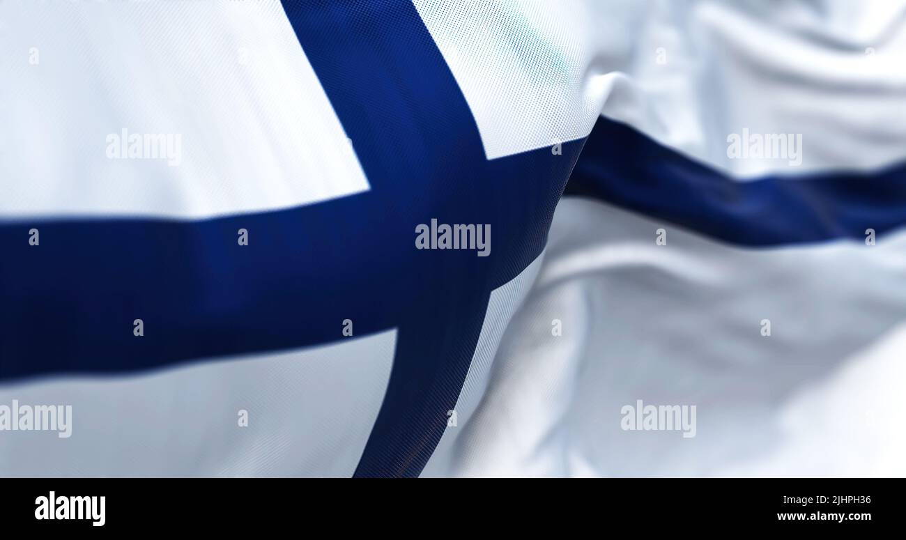 Close-up view of Finland national flag waving in the wind. Finland is a Scandinavian country located in northern Europe. Fabric background Stock Photo
