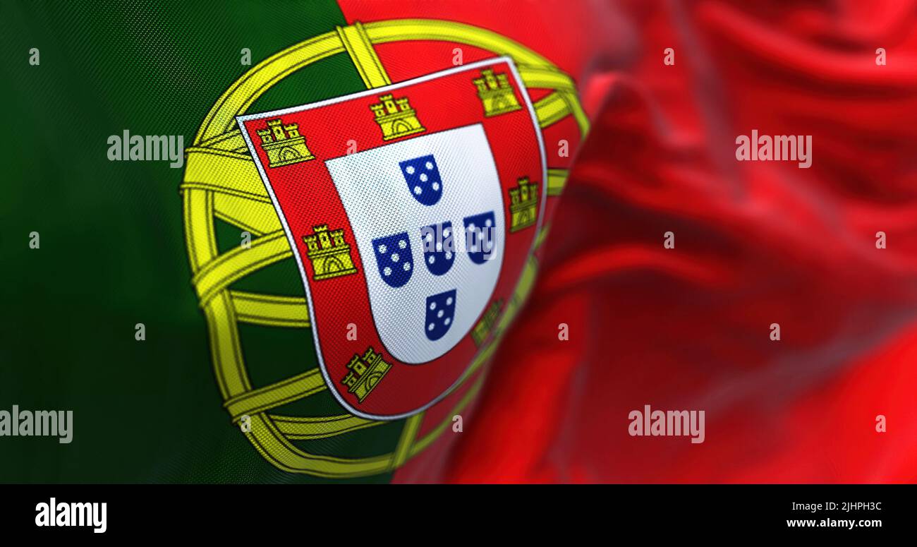 Close-up view of Portugal national flag waving in the wind. Portugal is an European country located in western Europe. Fabric background Stock Photo