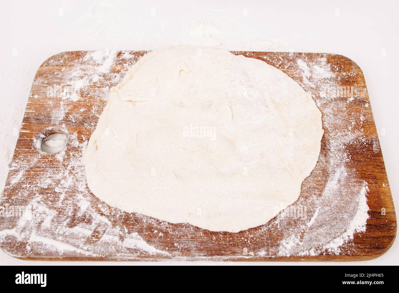 Rolled dough on wooden cutting board, free space Stock Photo