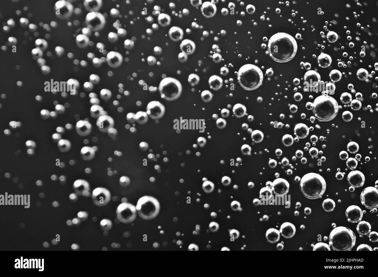 Dark oil with bubbles. Bubbles in liquid. Black and white. Oil concept. Oil business concept and petrol production Stock Photo