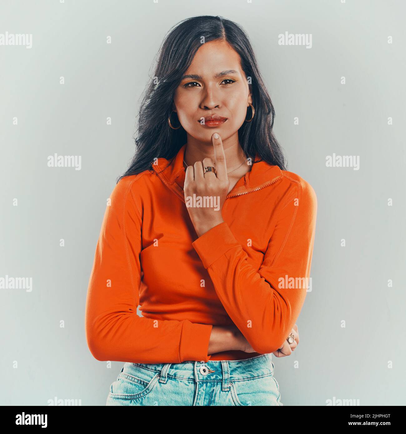 One mixed race woman isolated against grey studio background with
