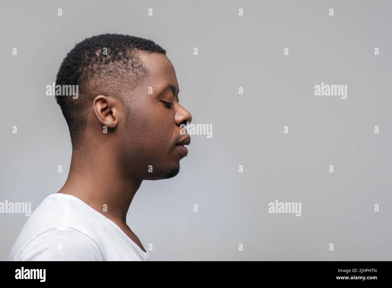 Concentrated black guy looking right. Profile view Stock Photo