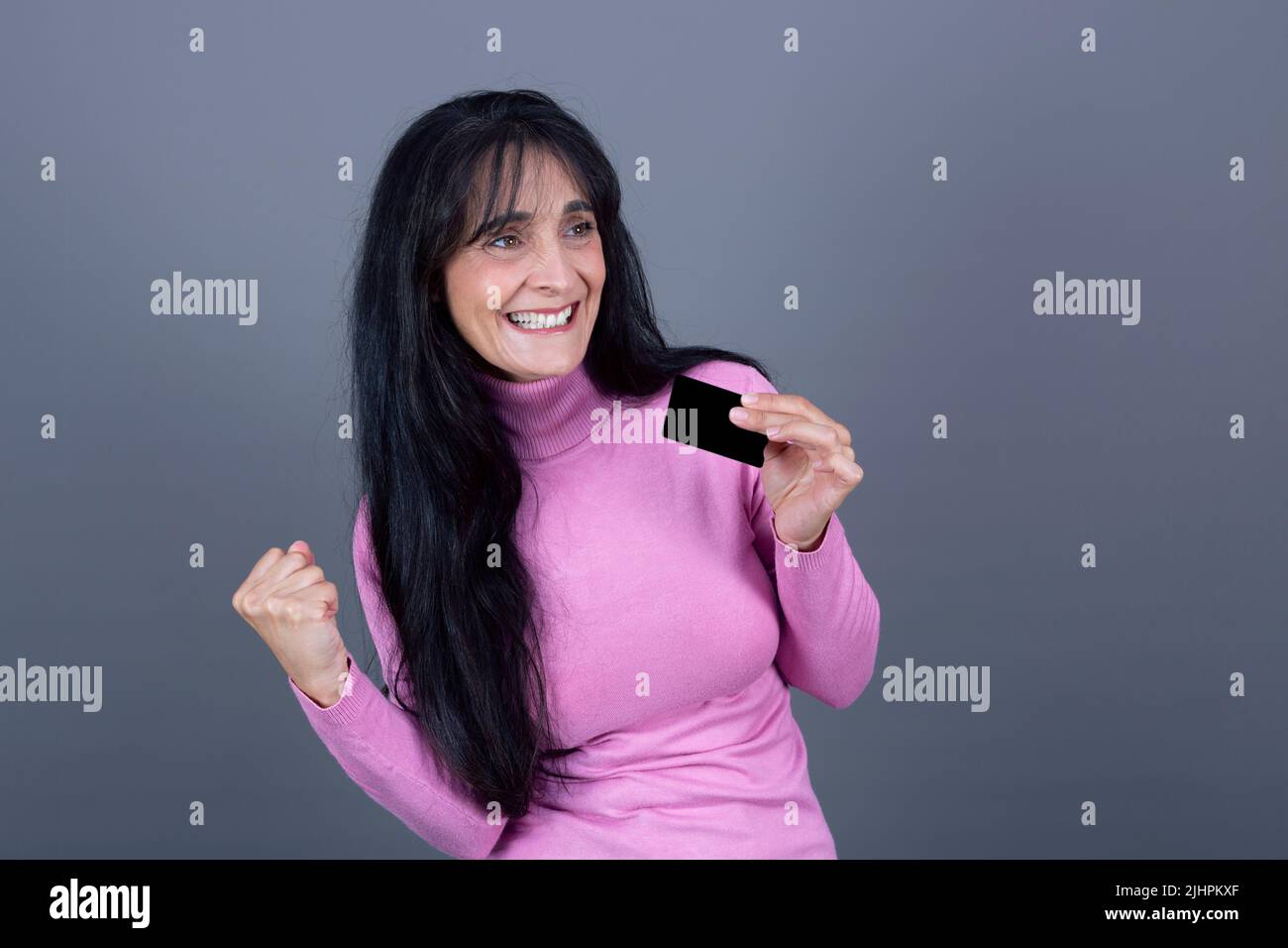 beautiful woman with gesture of celebration with credit card Stock Photo