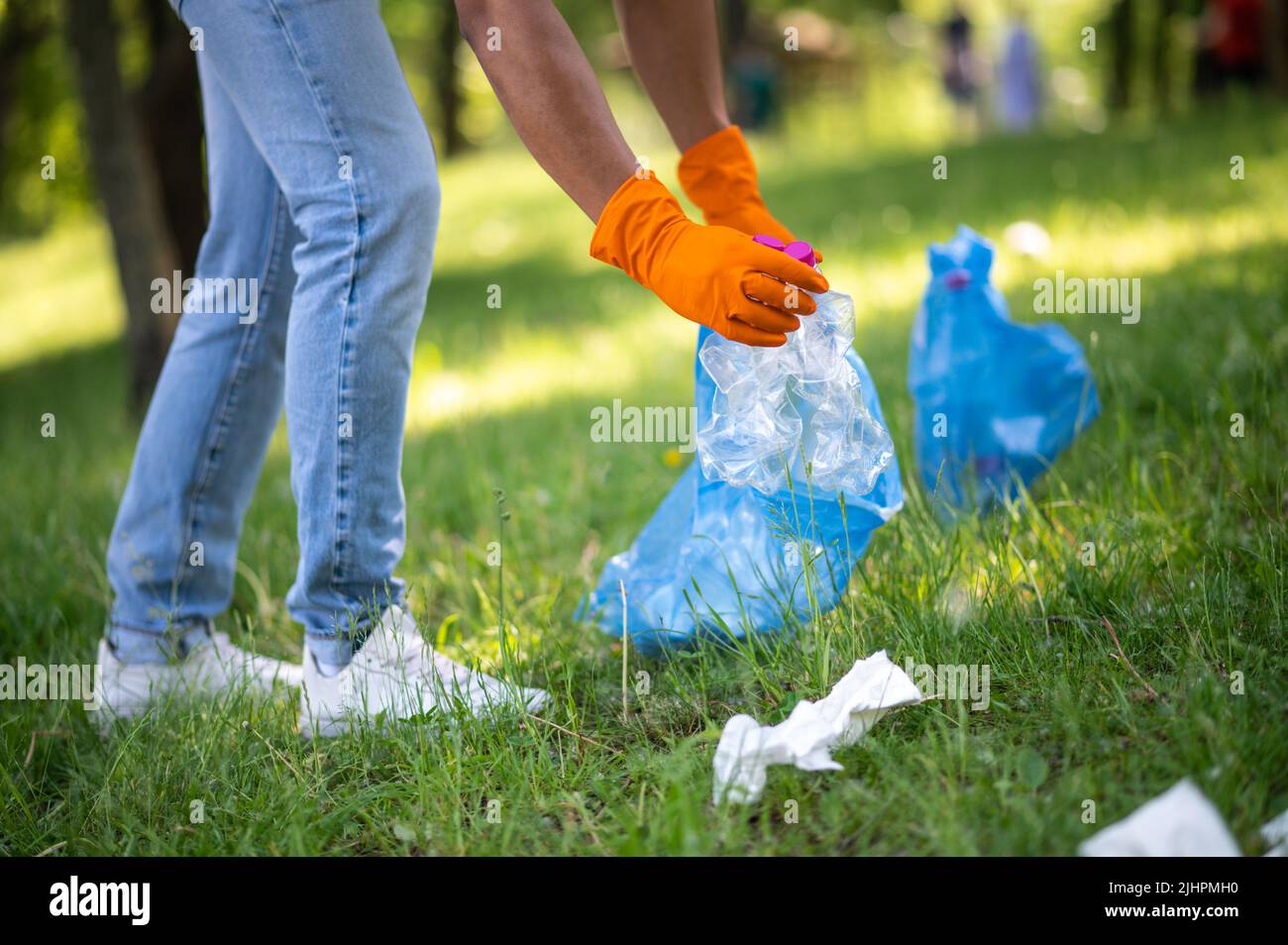 Hands of man putting plastic waste into bag Stock Photo Alamy
