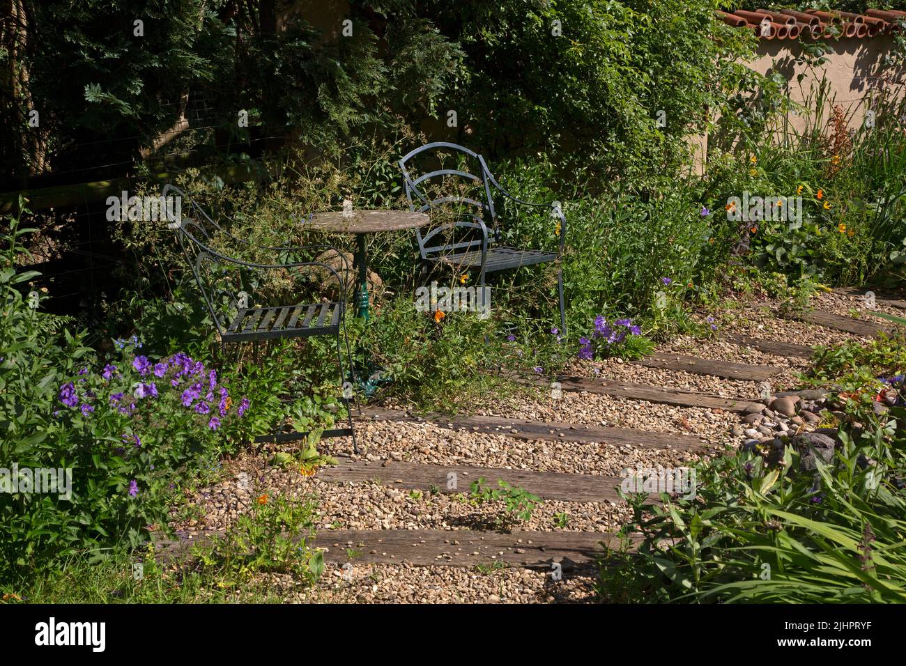 English garden path made with gravel and wooden sleepers Stock Photo