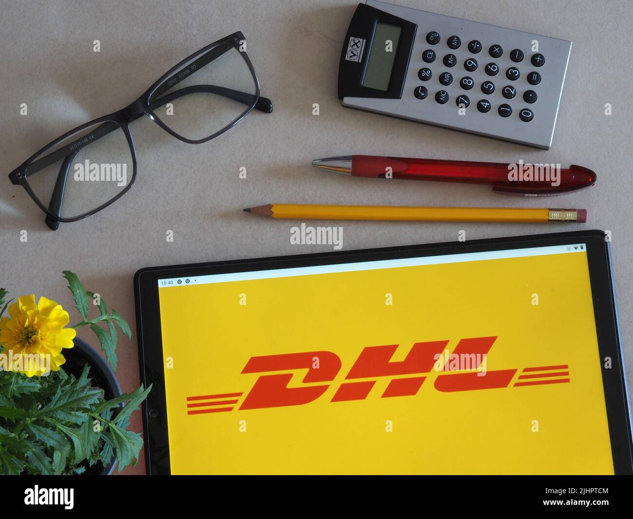 In this photo illustration, DHL logo seen displayed on a tablet. (Photo ...