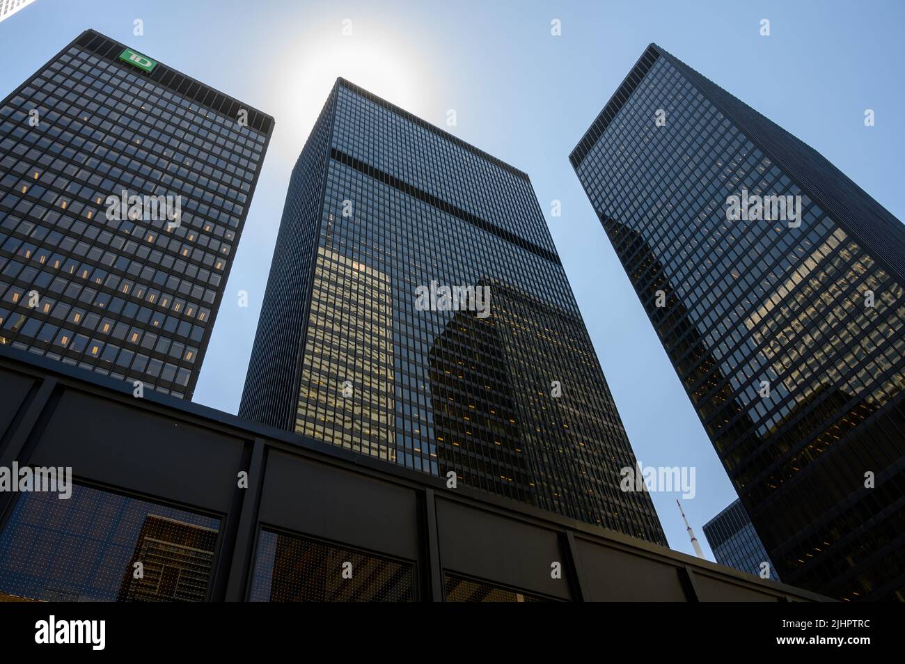 Looking up at the Toronto Dominion (TD) buildings with neighbouring skyscrapers reflected in the glass facades in financial district Toronto, Canada. Stock Photo