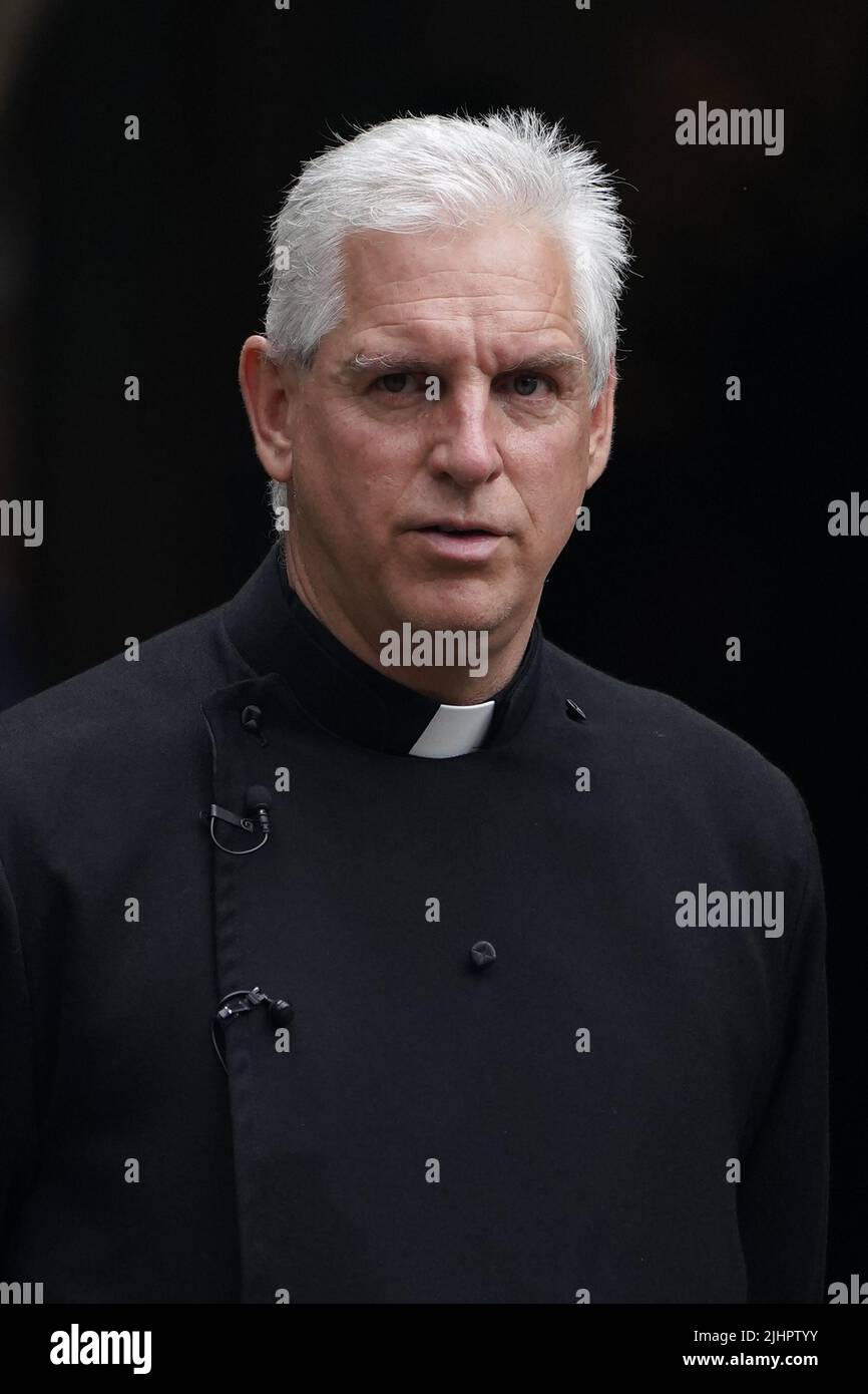 A member of the clergy outside the funeral service of Dame Deborah James at St Mary