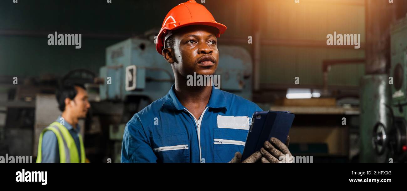 engineer use phone and tablet to control in industry Stock Photo