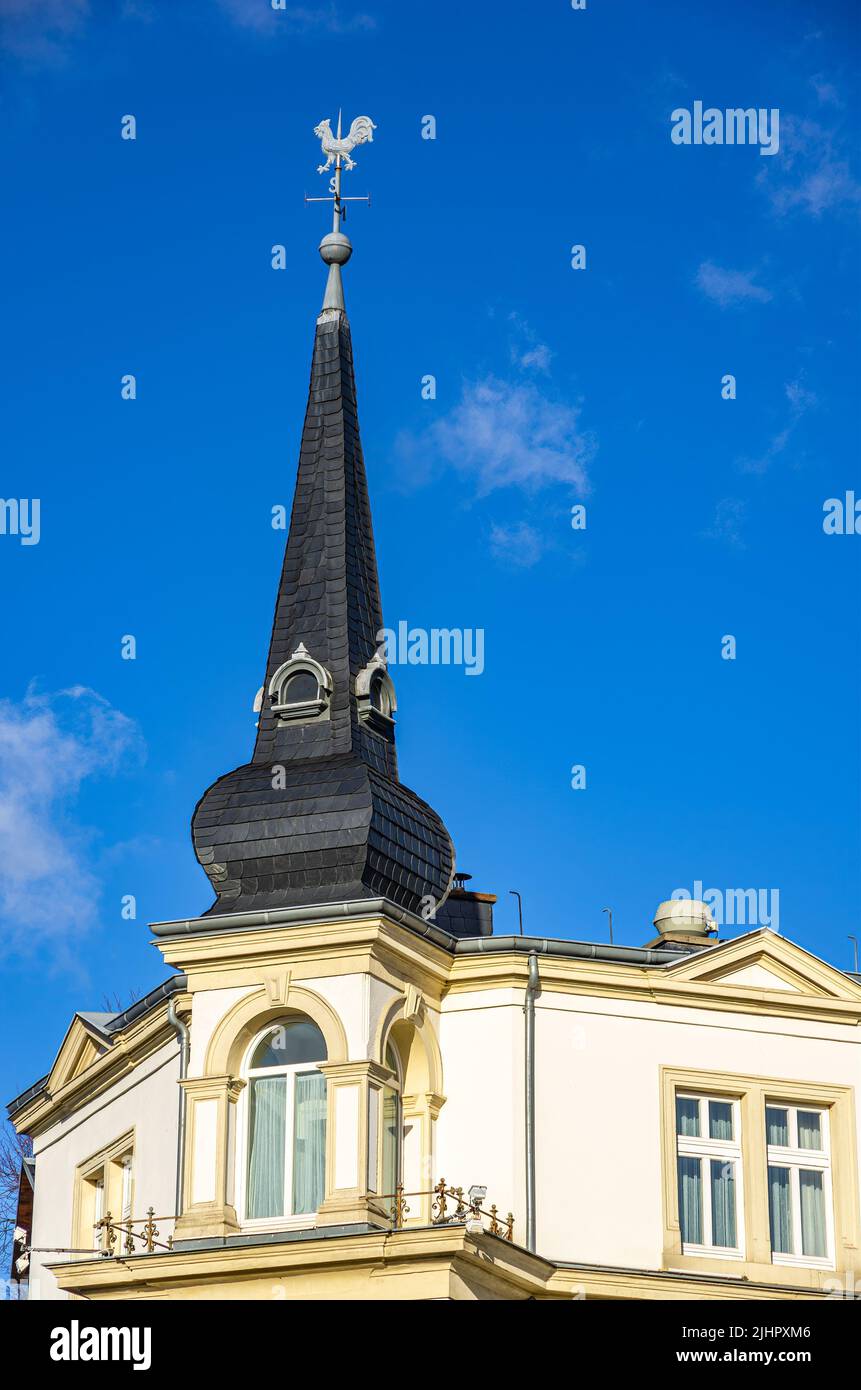 Dresden, Saxony, Germany: Southeast corner of the Kurhaus Klotzsche with pointed spire and weathercock with compass rose. Stock Photo