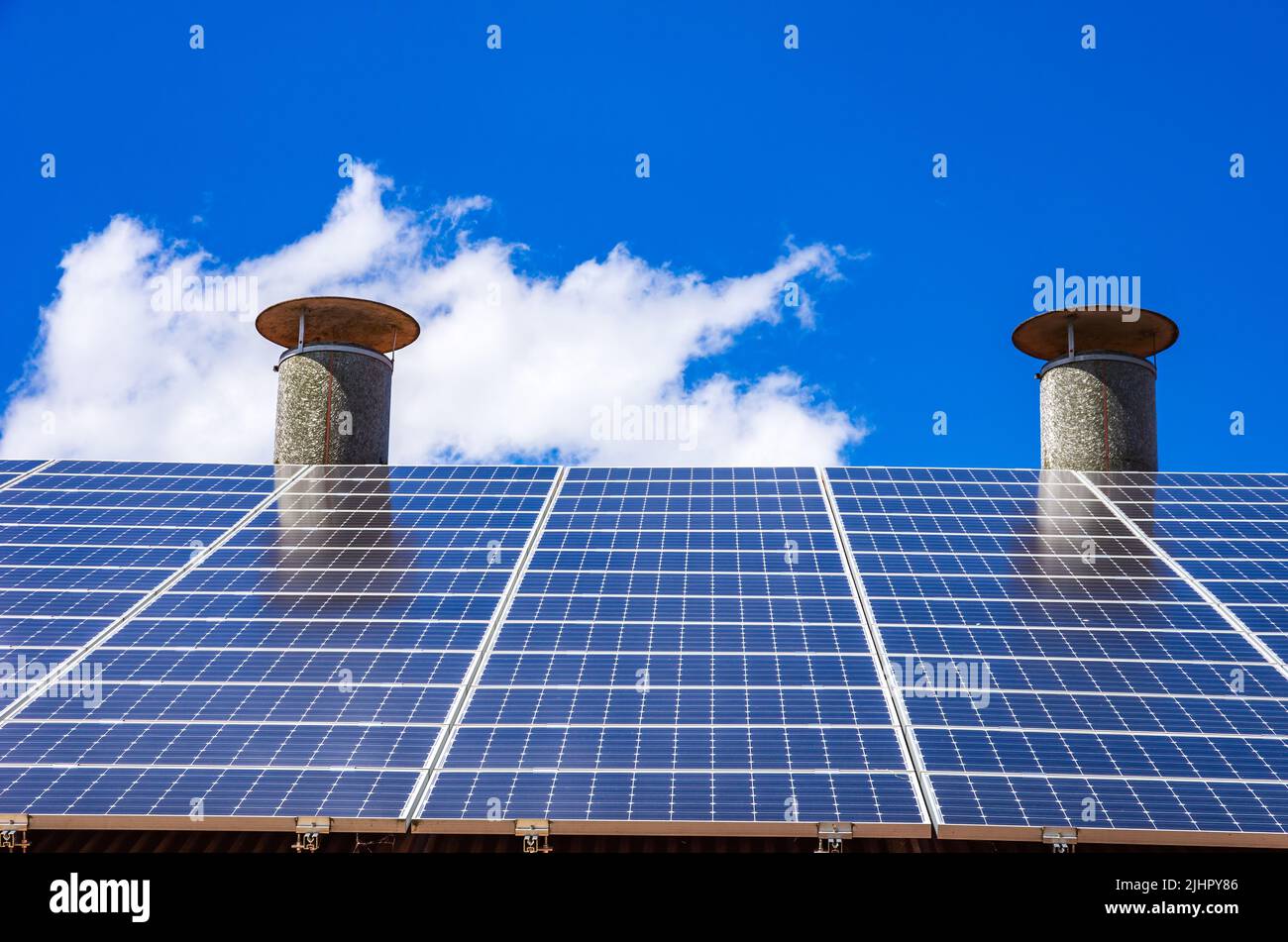 Domestic photovoltaic system or small solar power plant on a house roof. Stock Photo