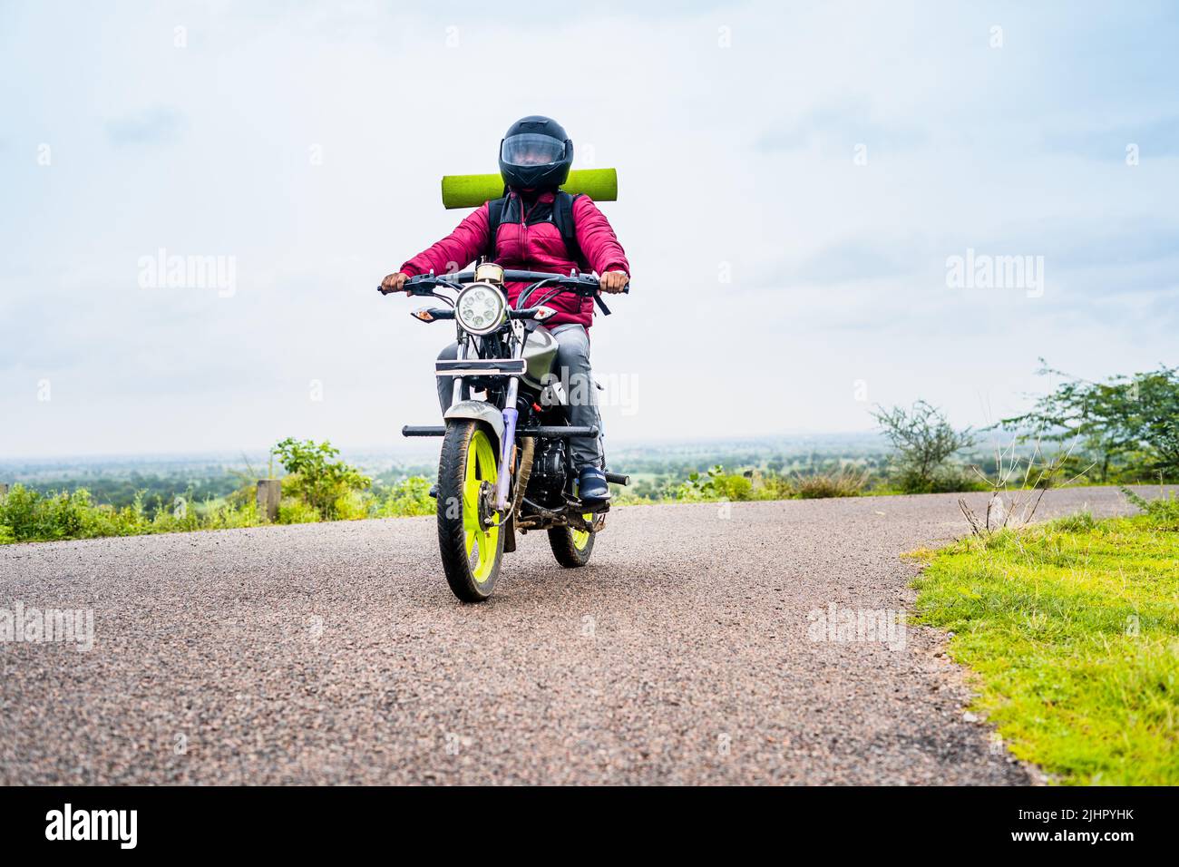 motorbke Rider with backpack traveling on motorbike near mountains on road - concept of freedom, weekend holidays and outdoor activities Stock Photo