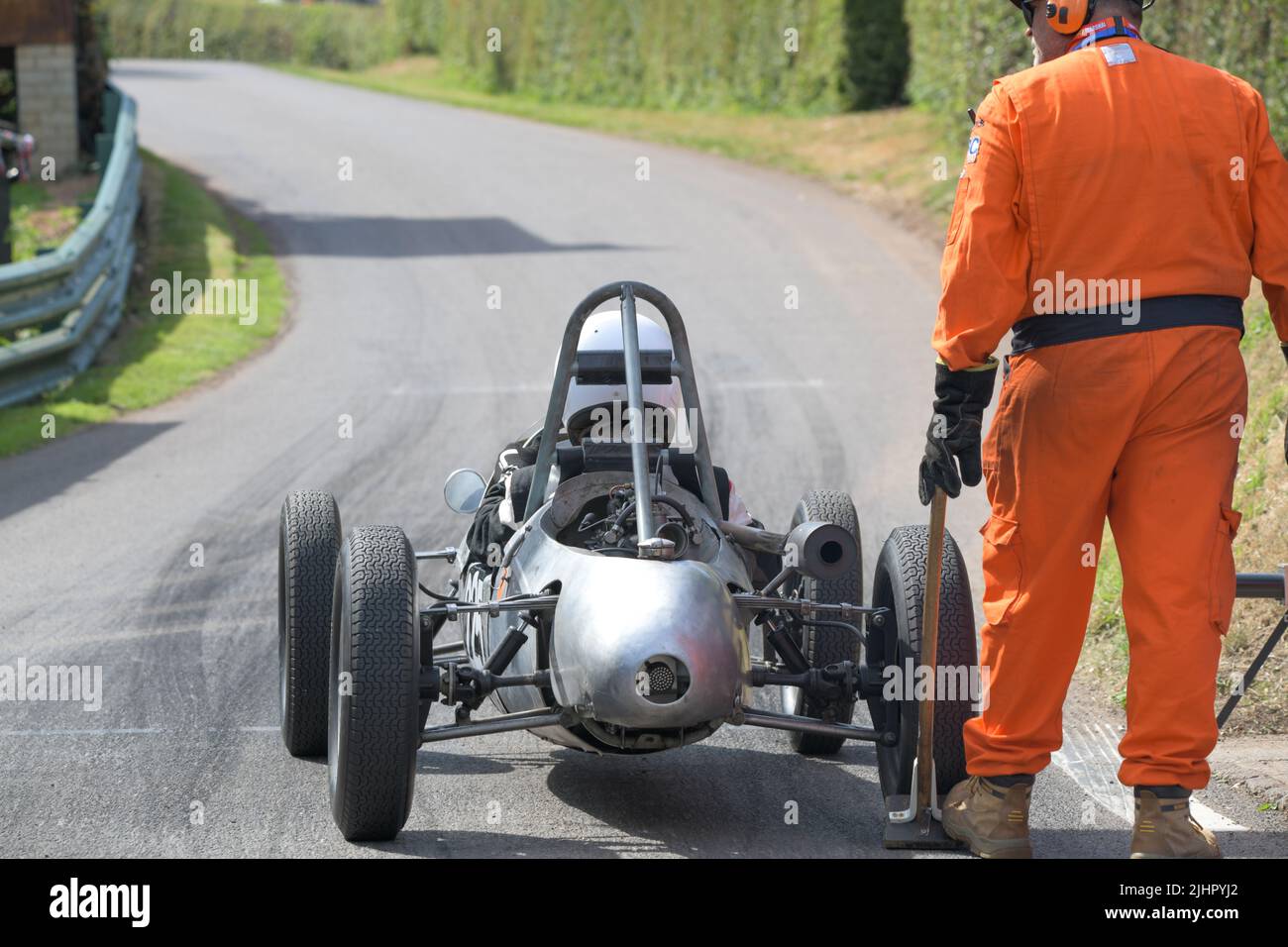 A silver Cooper Mk8 number 225, 500cc engine, at the start line at the Shelsey Walsh Classic Nostalgia event in July 2022, hill climb with a marshal Stock Photo