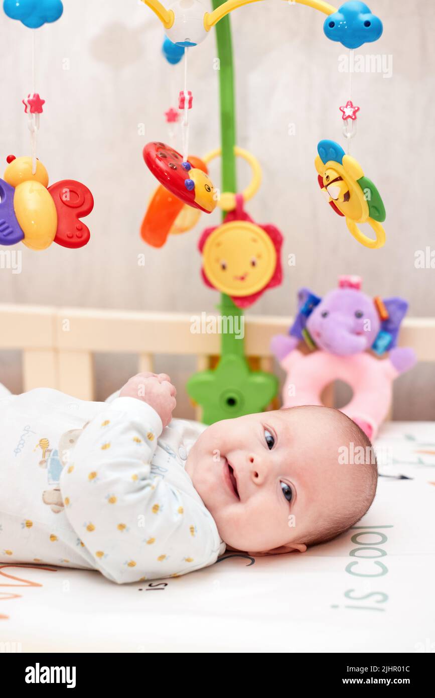 newborn baby in crib with toys at home Stock Photo - Alamy