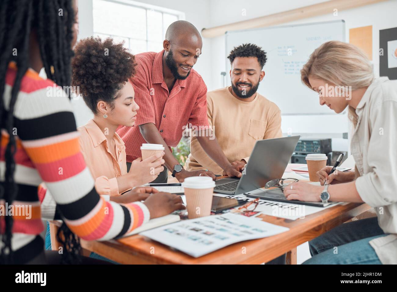 Group of happy diverse businesspeople having a meeting in a modern ...