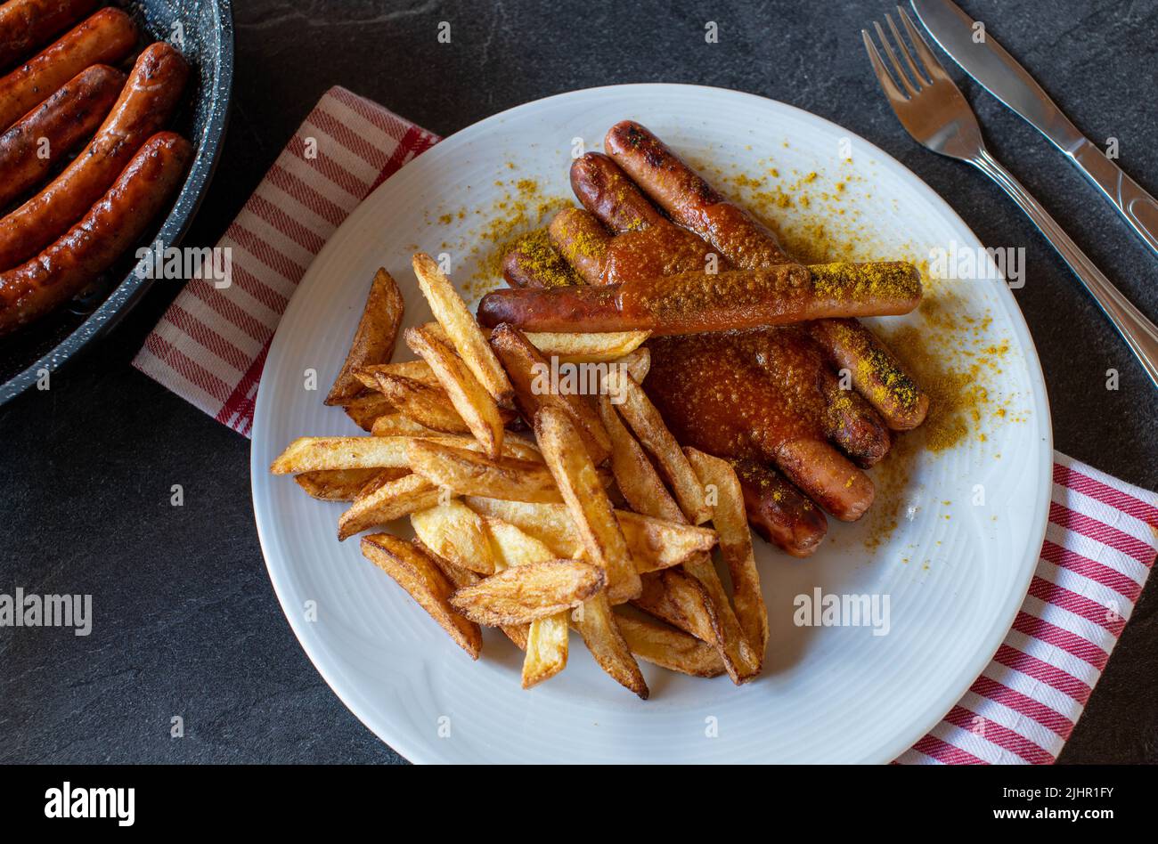 Vienna sausages with homemade french fries and curry sauce Stock Photo