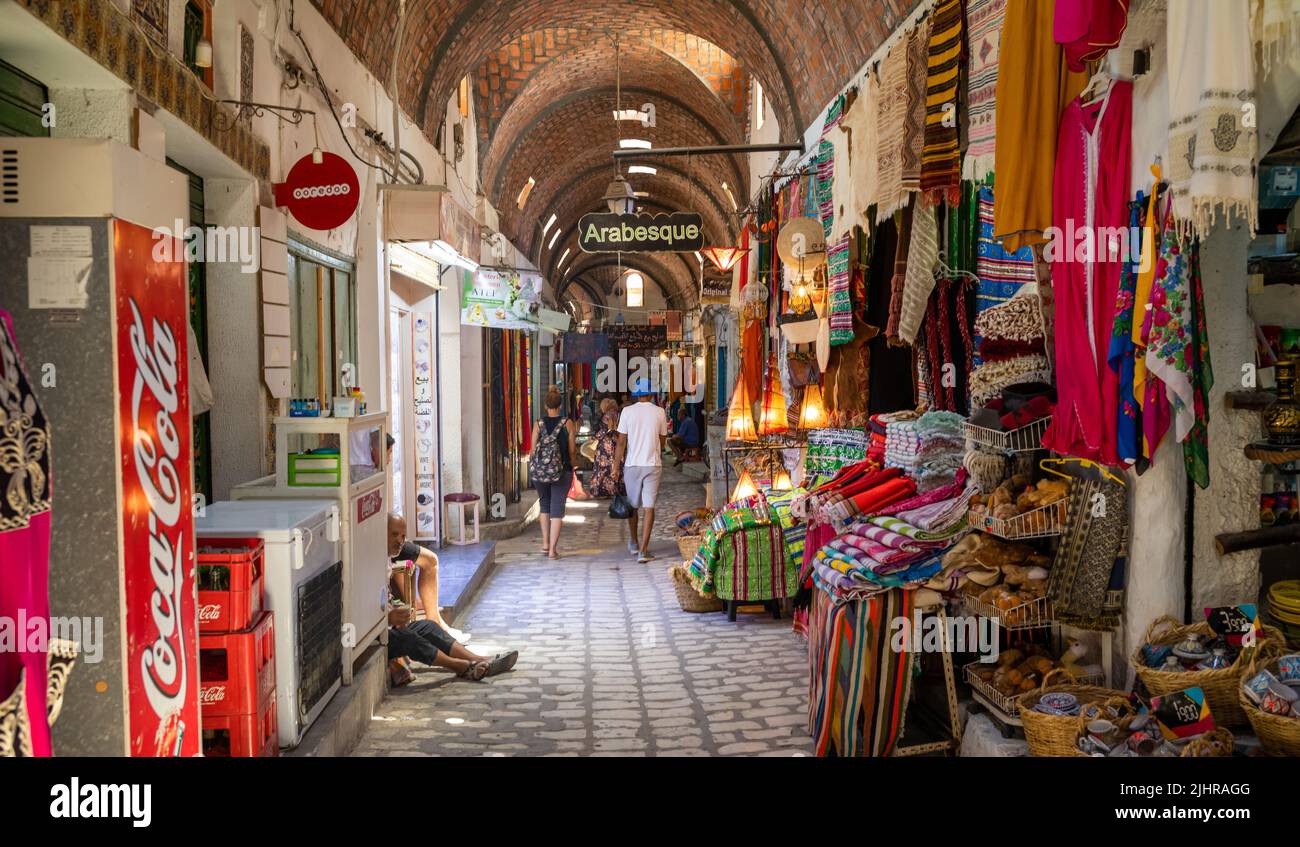 A vaulted passageway lined with shops inside then ancient souk housed within the Medina of Sousse in Tunisia. Stock Photo