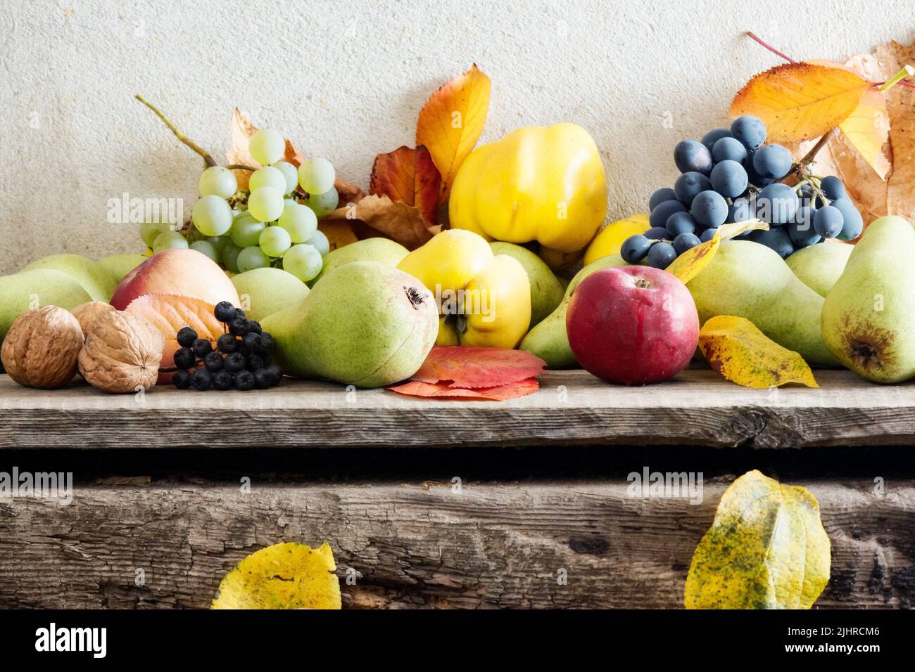 rural harvest on the wooden board. bunch of ripe fruits. organic healthy food and rustic still life composition Stock Photo