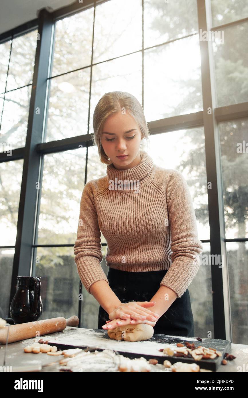 Young woman knead dough at kitchen, bakery making Stock Photo Alamy