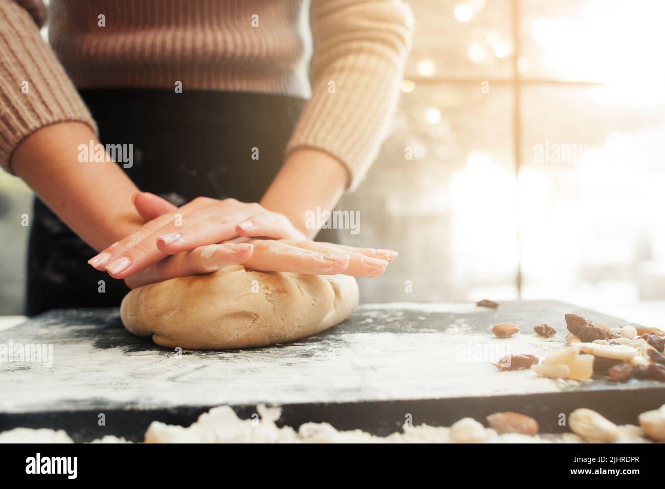Female hands kneading dough, sunset background Stock Photo - Alamy