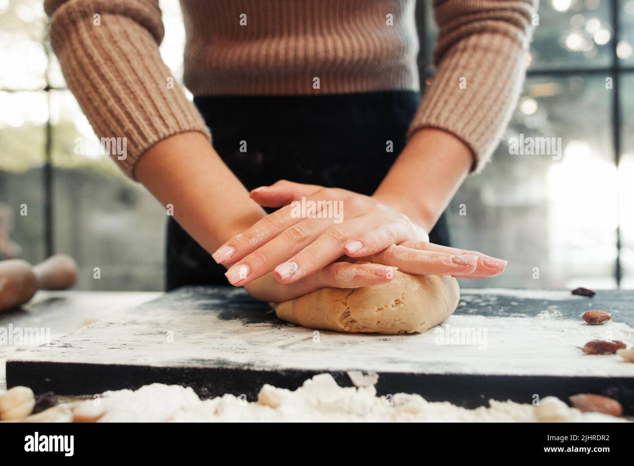 Female hands kneading dough, sunset background Stock Photo Alamy