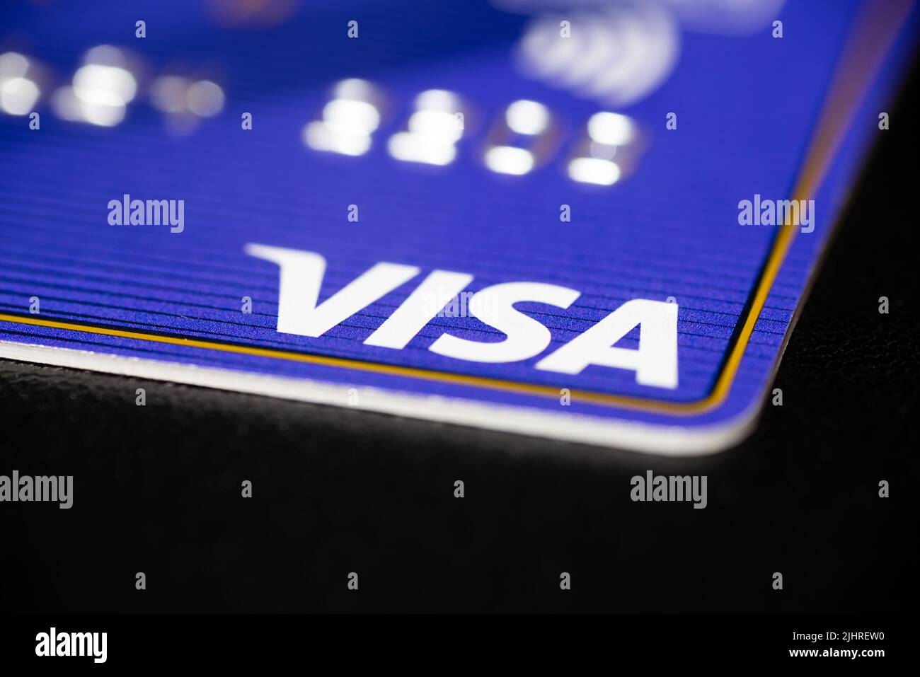 Visa credit card on a black surface table. Stock Photo