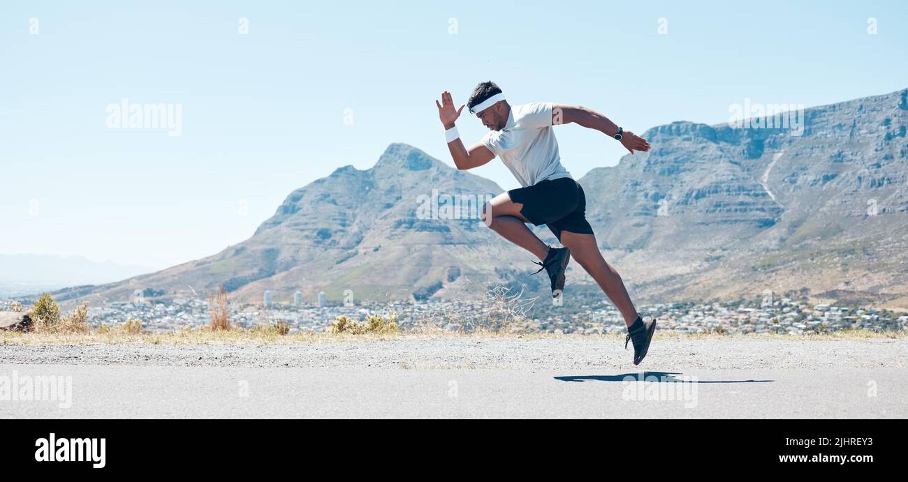 A fit handsome mixed race handsome young man wearing sunglasses running