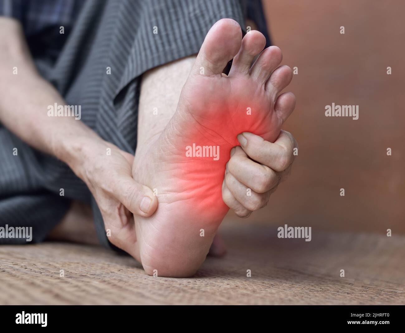 Itchy foot skin of Asian elder man. Concept of skin diseases such as scabies, fungal infection, allergy, etc. Stock Photo