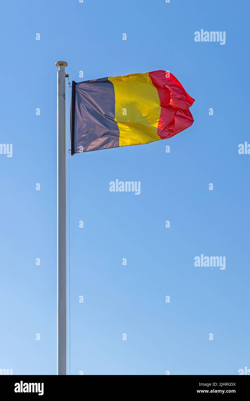 Kingdom of Belgium Flag at Blue Sky Sunny Day Stock Photo