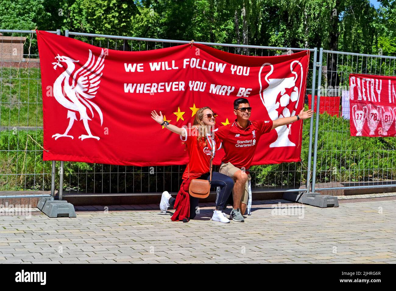 KIEV, UKRAINE - MAY 26: Happy Liverpool fans in red uniform near big banner before UEFA Champions League Final 2018 on May 26, 2018 in Kiev, Ukraine. Stock Photo