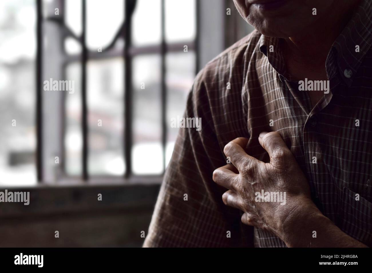 Asian elder man suffering from right sided chest pain. Chest pain can