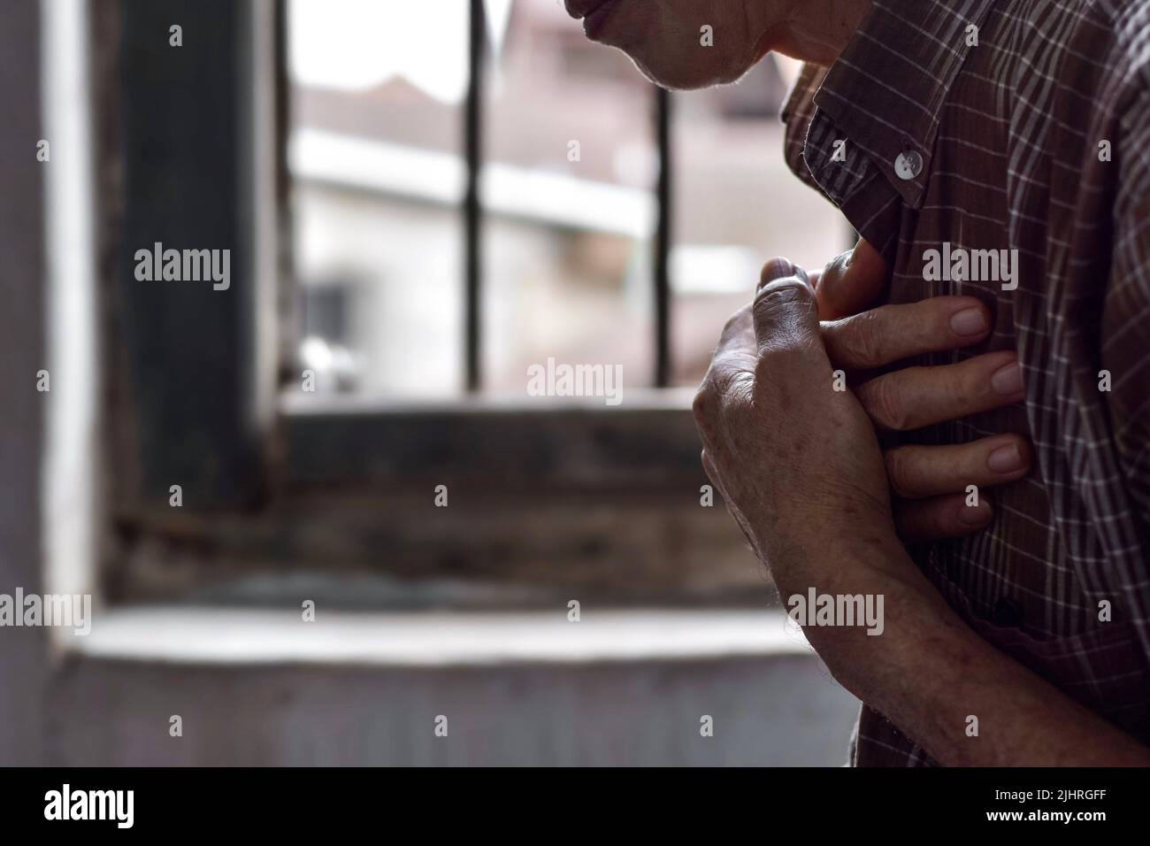 Asian elder man suffering from central chest pain. Chest pain can be