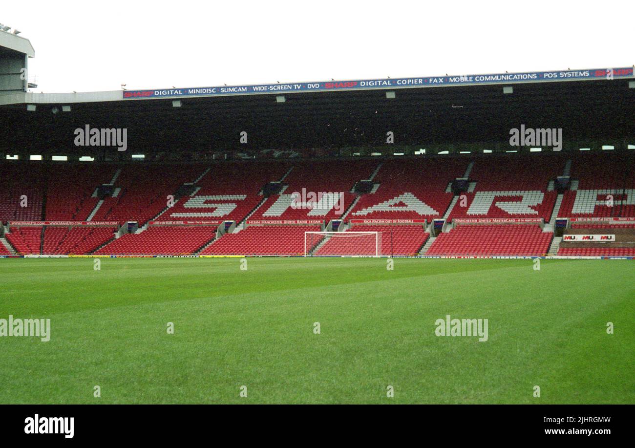 1990s, view of the Old Tradford stadium, home of Manchester United Football Club, Manchester, England, UK. In this era, the famous North of England club were sponsored by Sharp, a Manchester based consumer and professional electronics maker, whose name can ben seen across the seating. Stock Photo