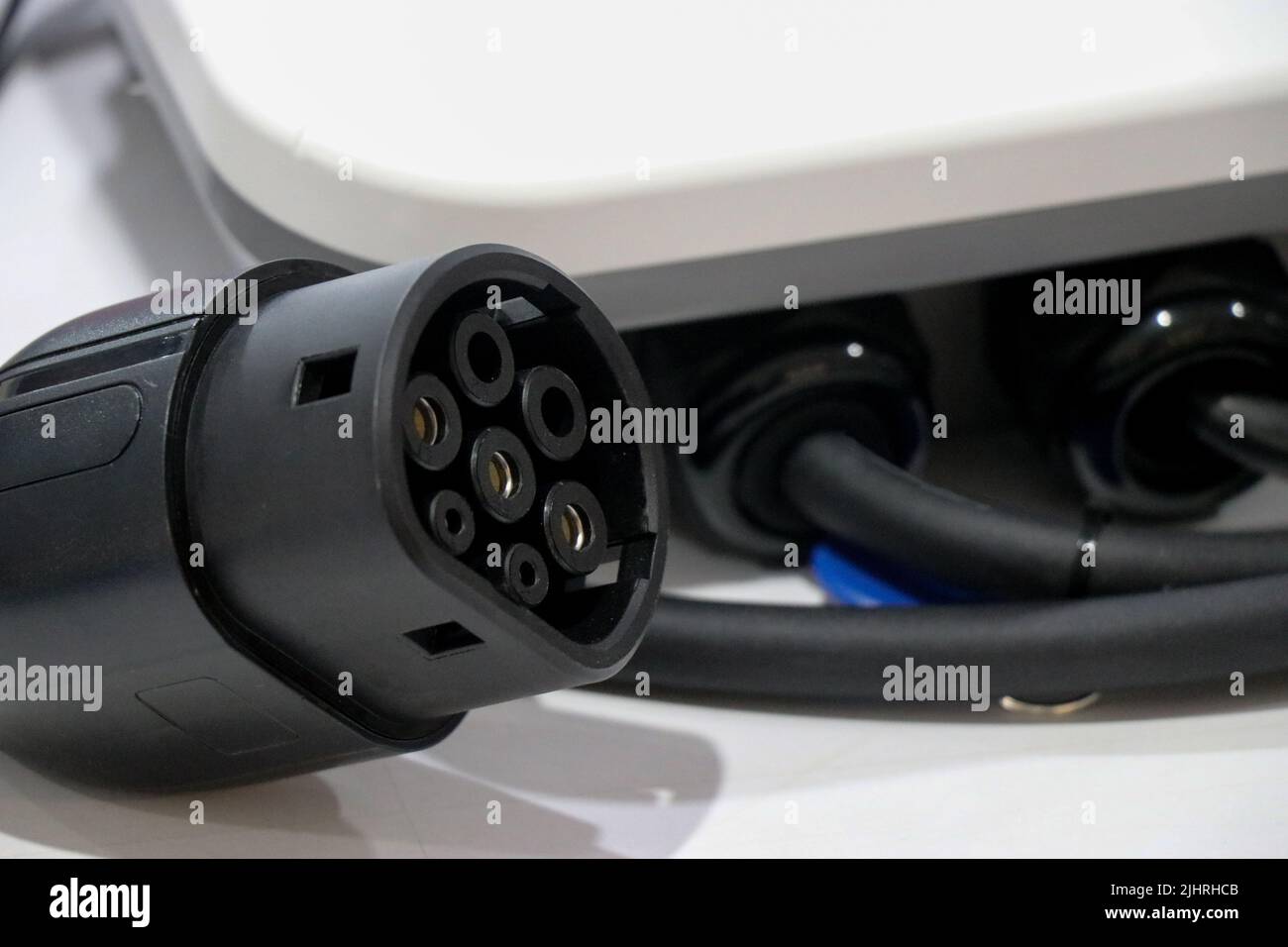 An Electric car charger plug of type 2 with its panel on a white background, EV or electric vehicle Charging Connector type 2 Stock Photo