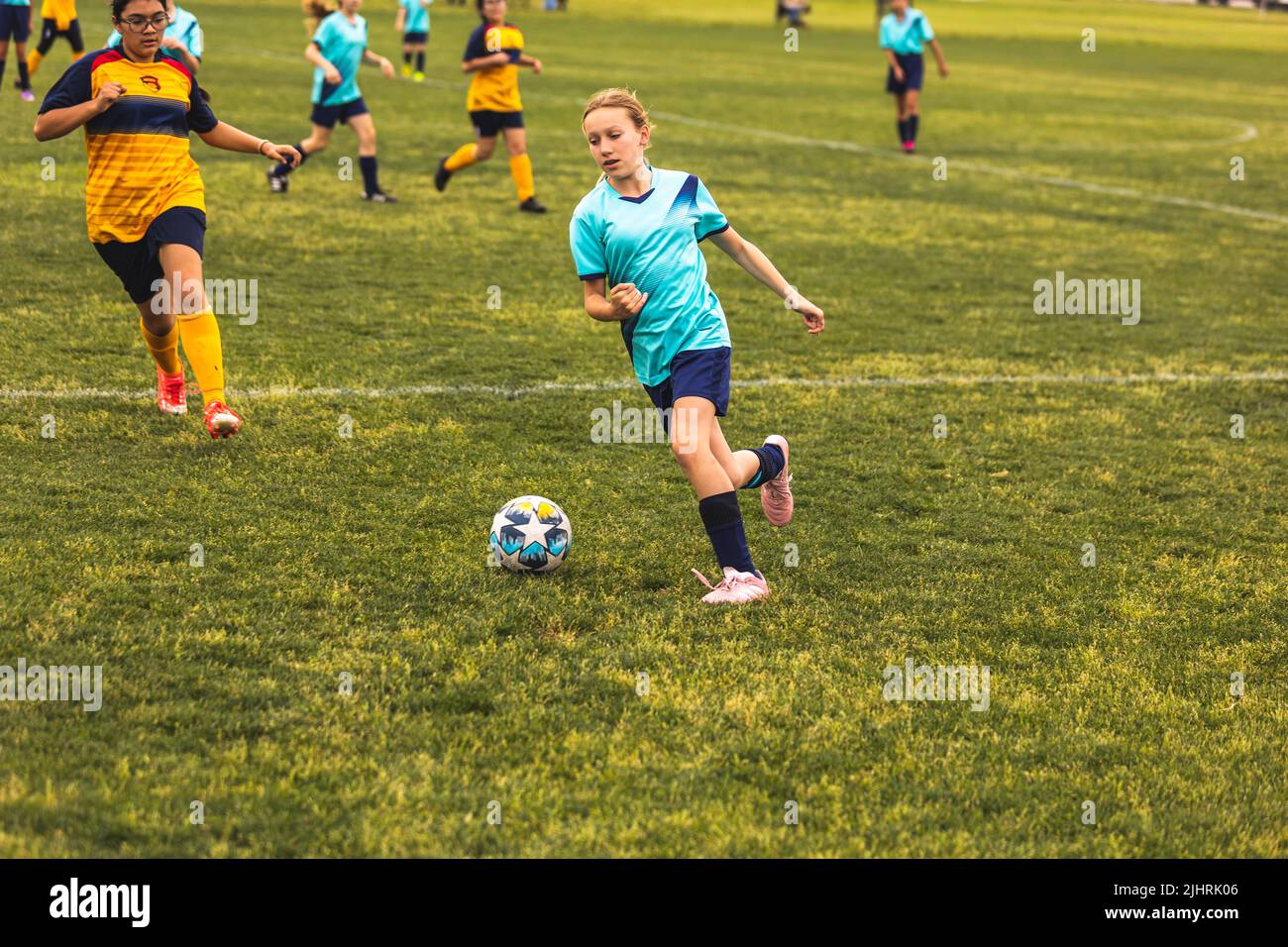 The young girls playing soccer at Youth Soccer Game Stock Photo Alamy