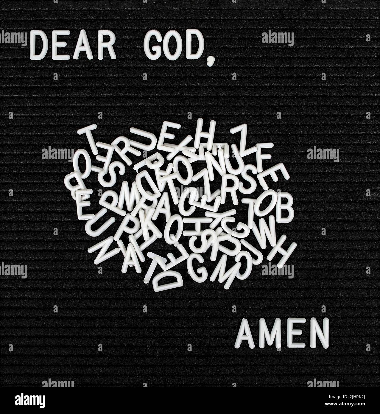 Prayer with scattered plastic white letters on a black felt bulletin board Stock Photo
