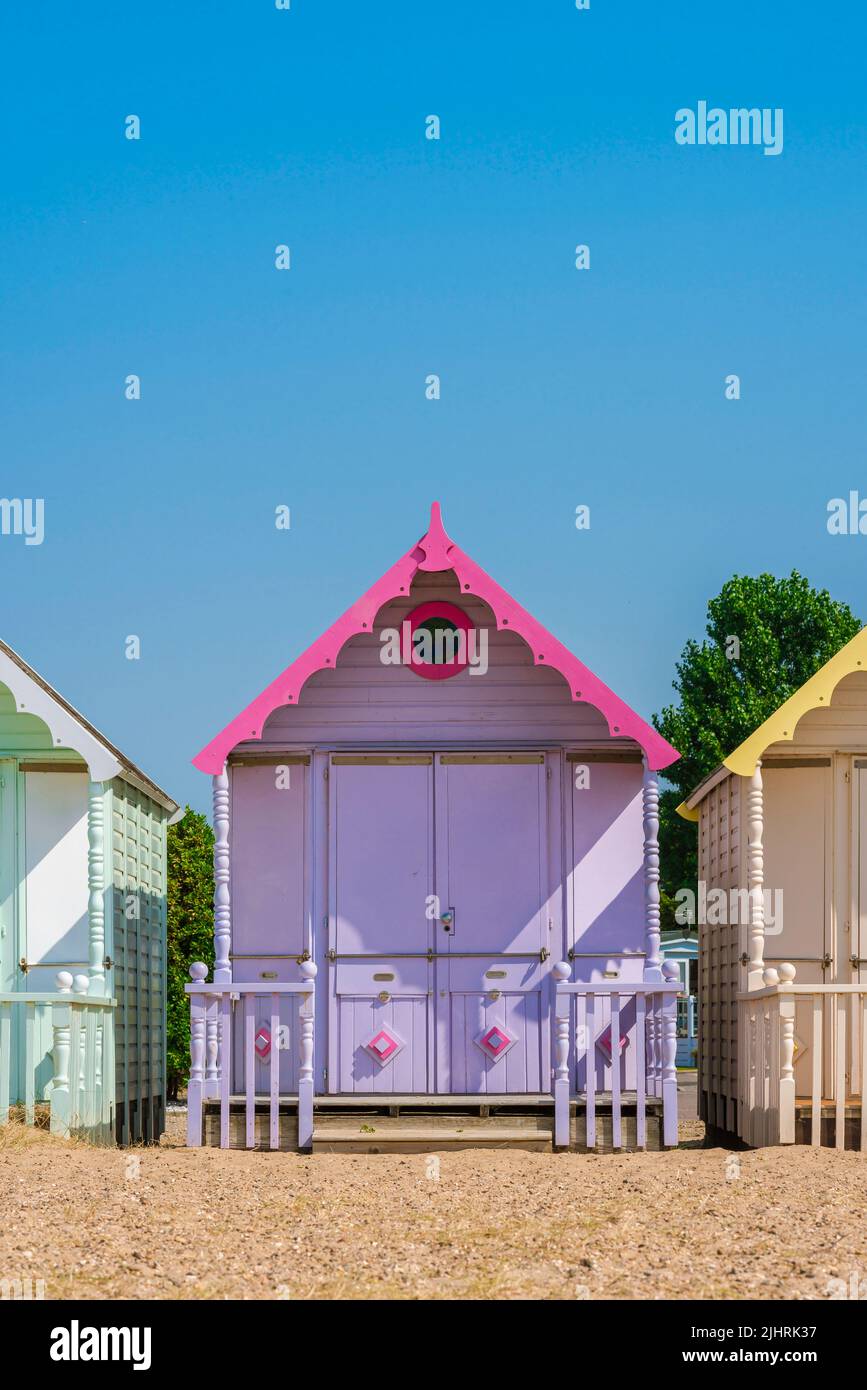 Beach holiday, view in summer of a colorful beach hut under a clear blue sky. Stock Photo