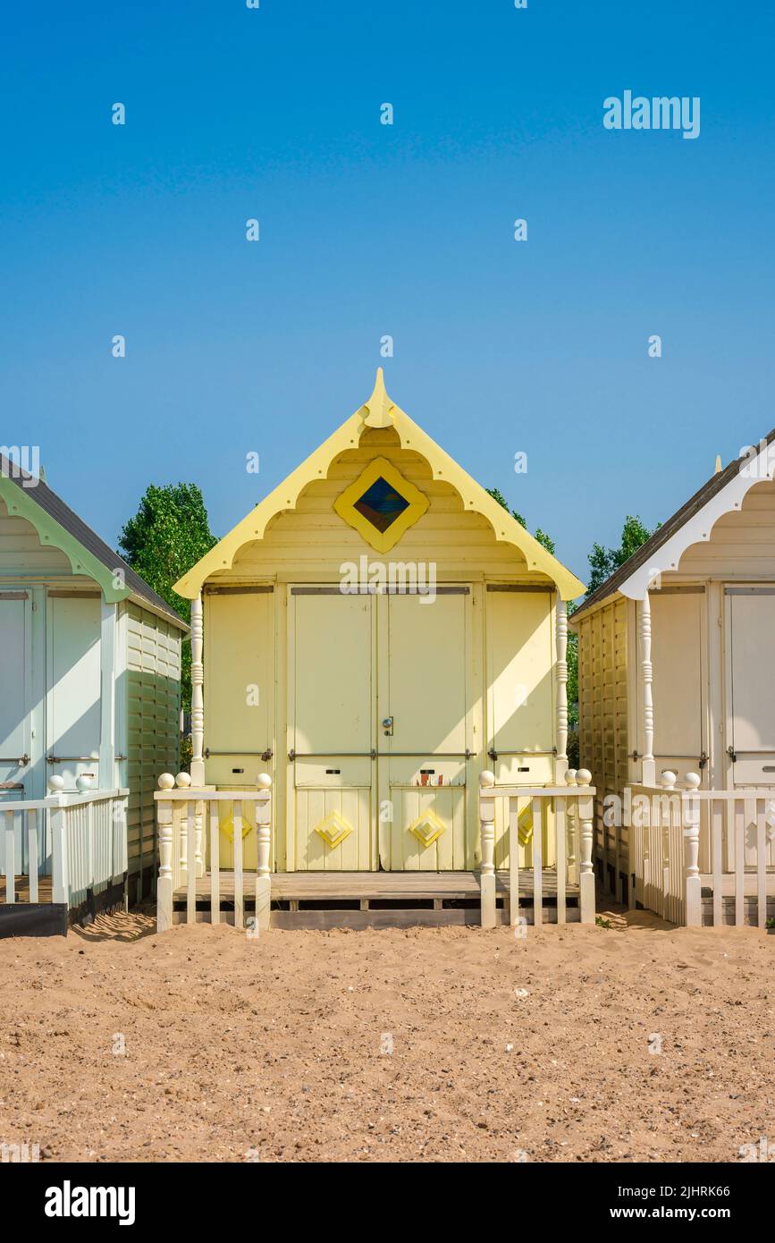 Beach vacation, view in summer of a colorful beach hut under a clear blue sky. Stock Photo