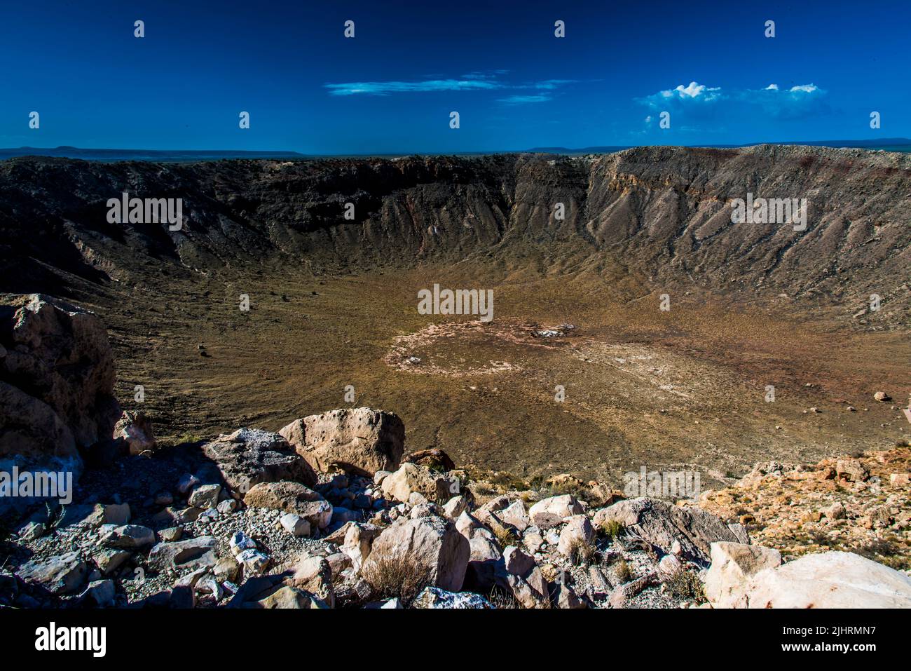 The Meteor Crater ( Barringer Crater) with rocks under a blue sky Stock ...