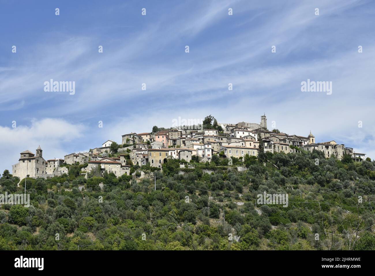 A beautiful view of Fontana Liri village on a green hill with trees under a  blue sky Stock Photo - Alamy