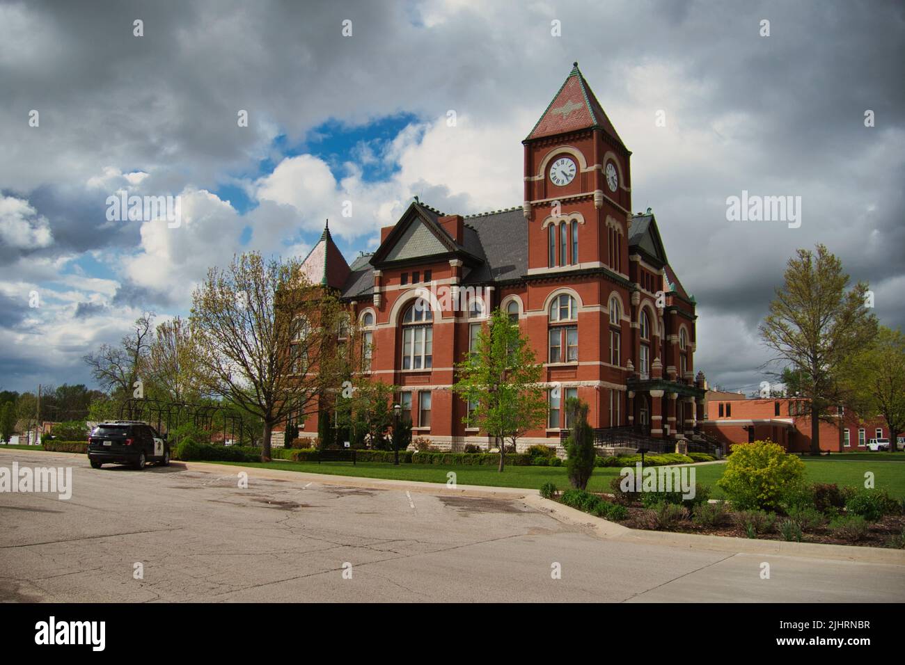 A view of a Historic Miami County Kansas (KS) Courthouse in Paola on a dark cloudy day Stock