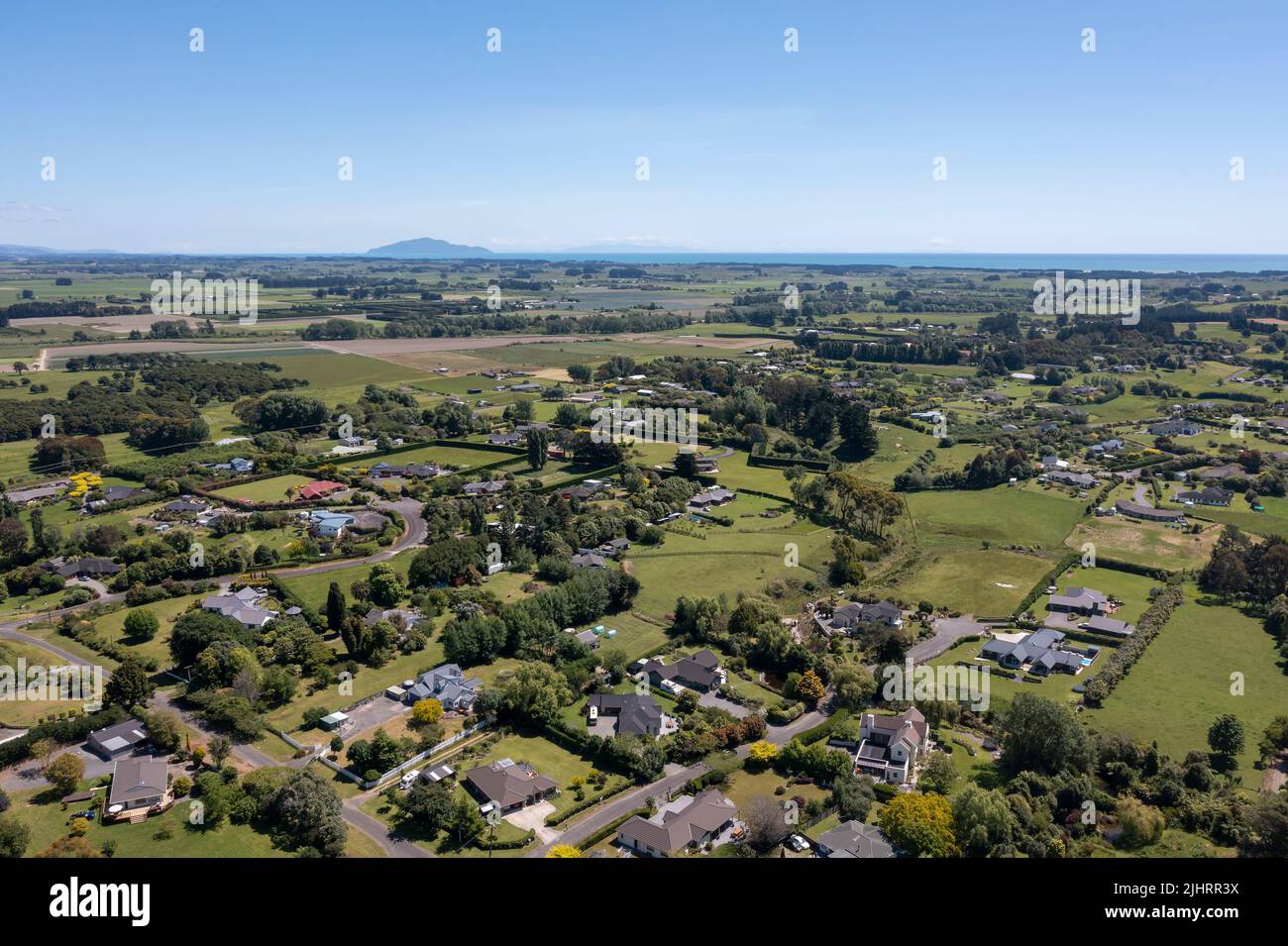 Aerial of Ohau village Horowhenua region of New Zealand with flat fertile farmland, lifestyle housing. Looking south to Kapiti Island and Tasman Sea Stock Photo