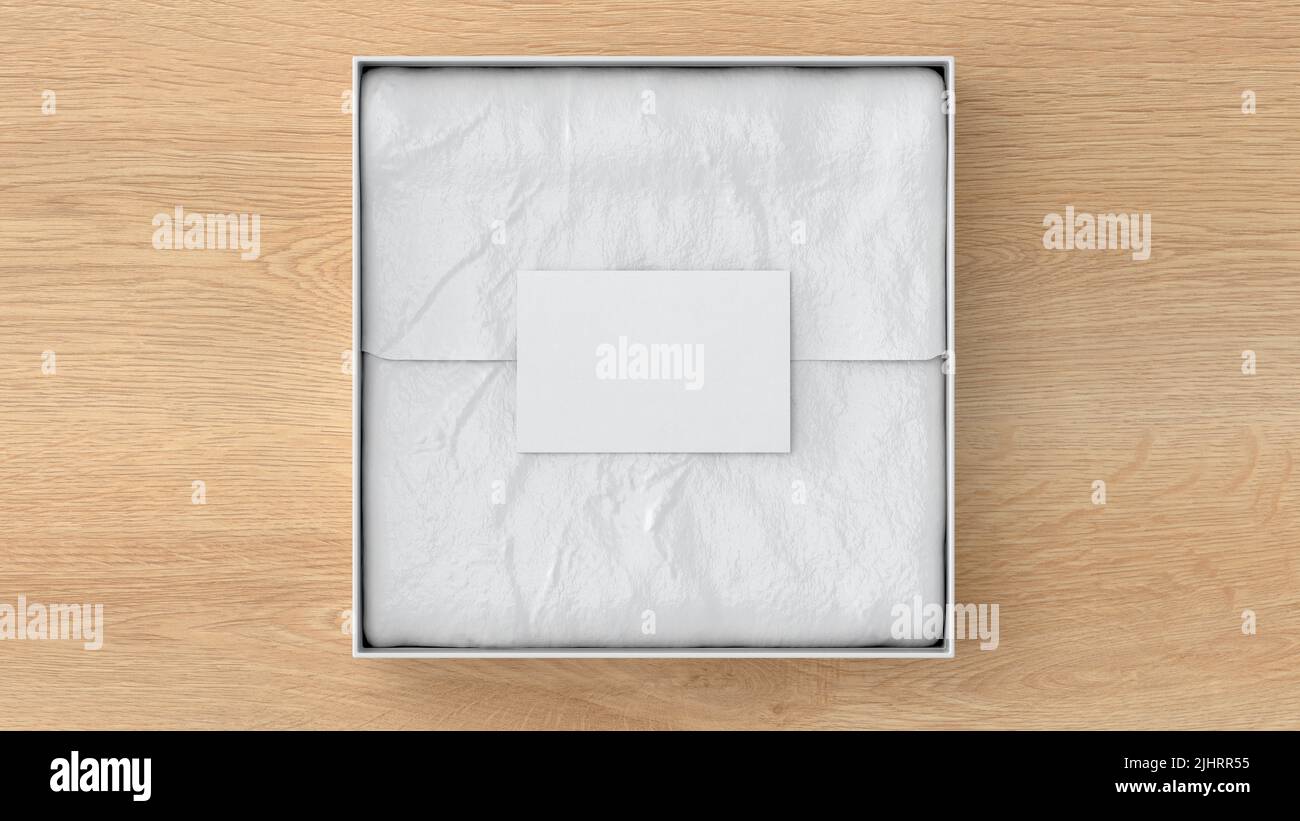 Square gift box mock up. White gift box with blank label or business card on wrapping paper. Wooden background. View directly above. 3d illustration Stock Photo