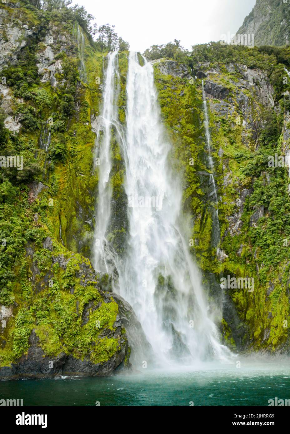 A vertical shot of a waterfall over the rocks Stock Photo - Alamy