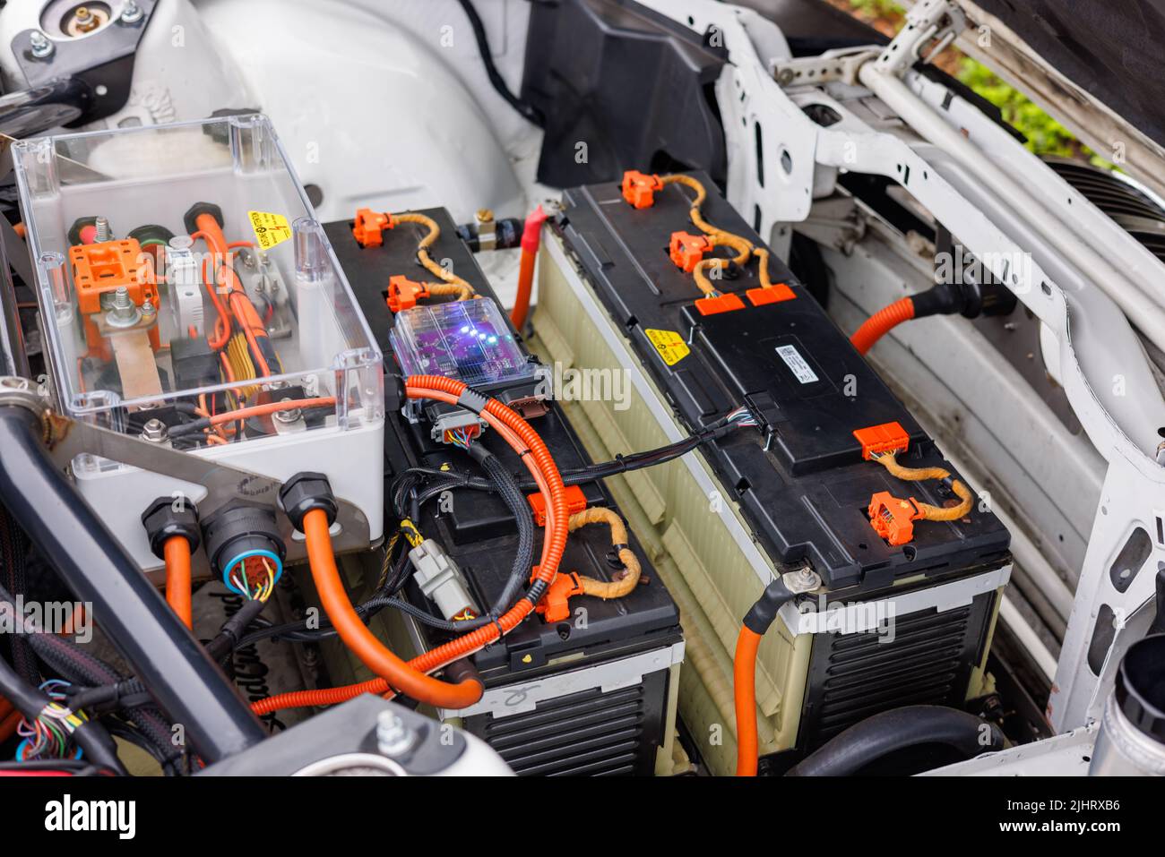 A closeup of batteries and electric motor in place of gas engine