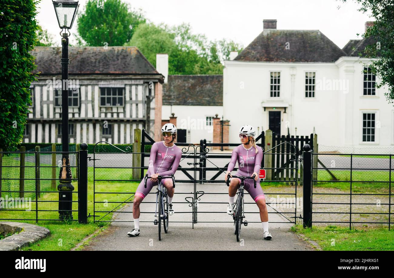 The two professional cyclers sitting on their bike in front of a building in Birmingham, United Kingdom Stock Photo