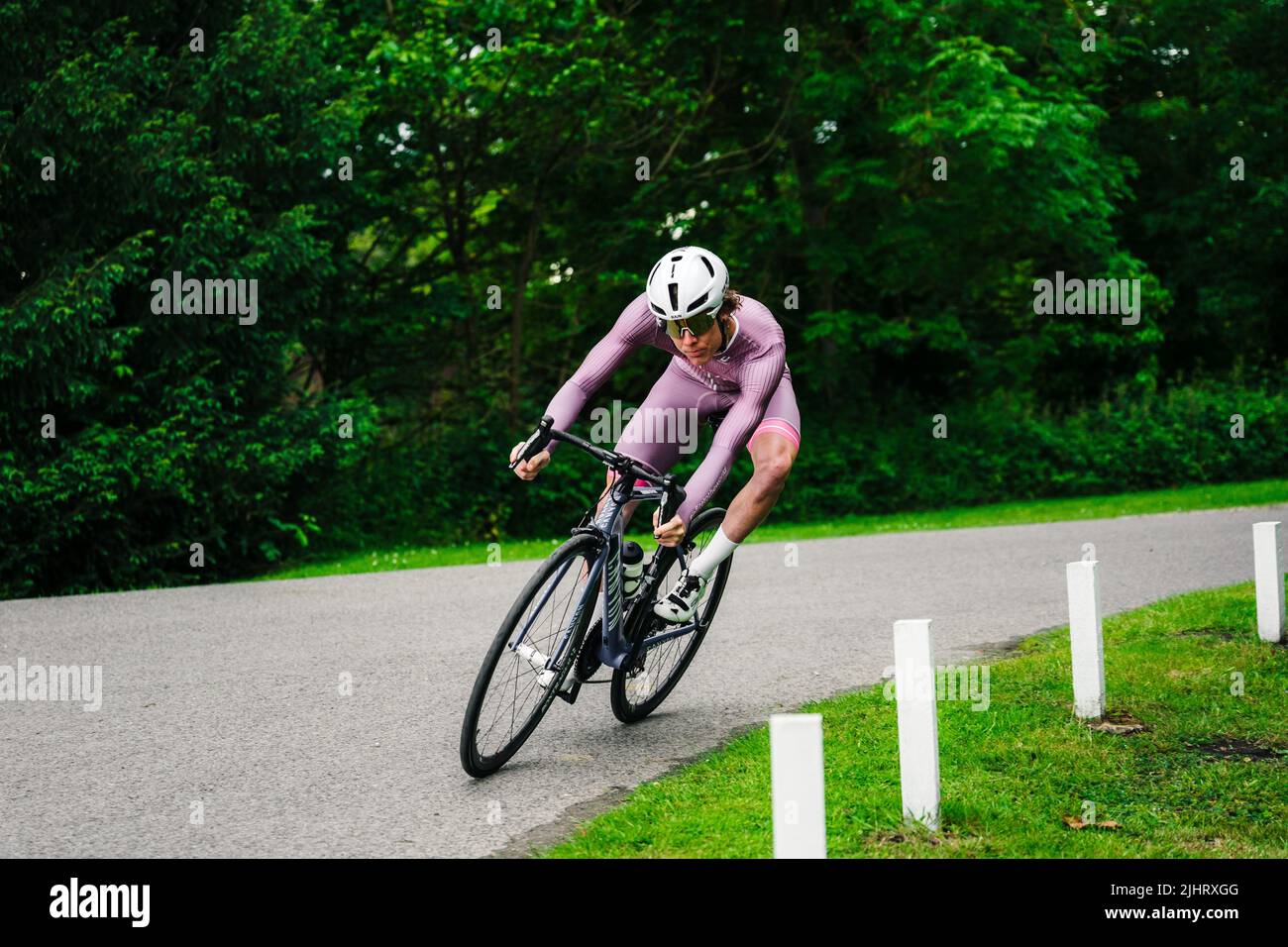 A professional cycler riding at speed around the corner in Birmingham