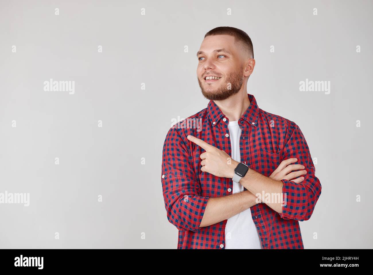 Young handsome bearded man pointing to the side Stock Photo
