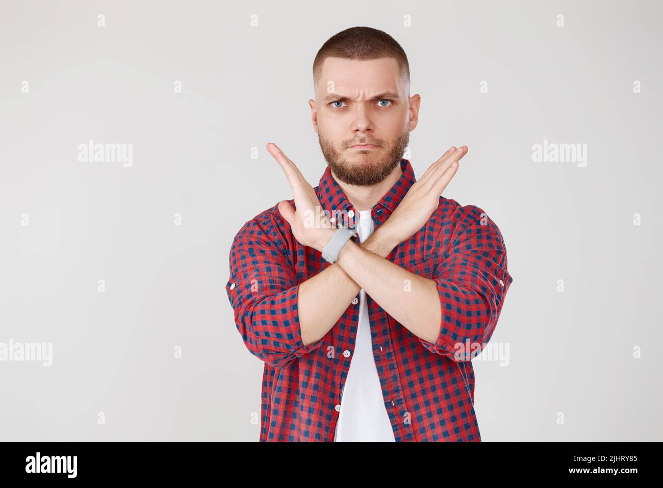 Young bearded man making stop gesture hand Stock Photo
