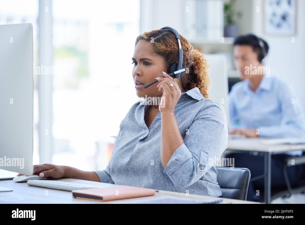 One stressed and confused mixed race call centre telemarketing agent